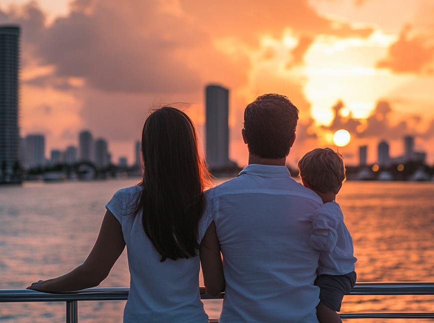 a family of three takes in the views of Miami at sunset 